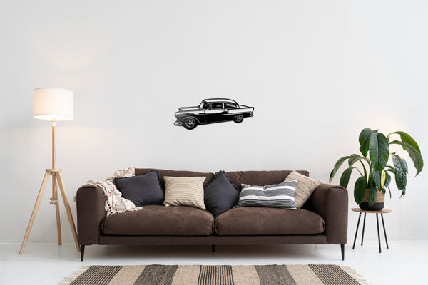 Beautiful hand finished Chevrolet two-ten metal wall art painted black showing above a sofa on a light coloured wall