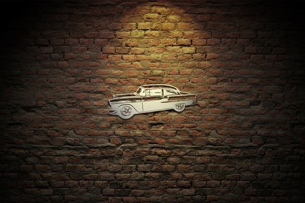 Beautiful hand finished Chevrolet two-ten metal wall art, in a bare steel finish showing on a brick wall